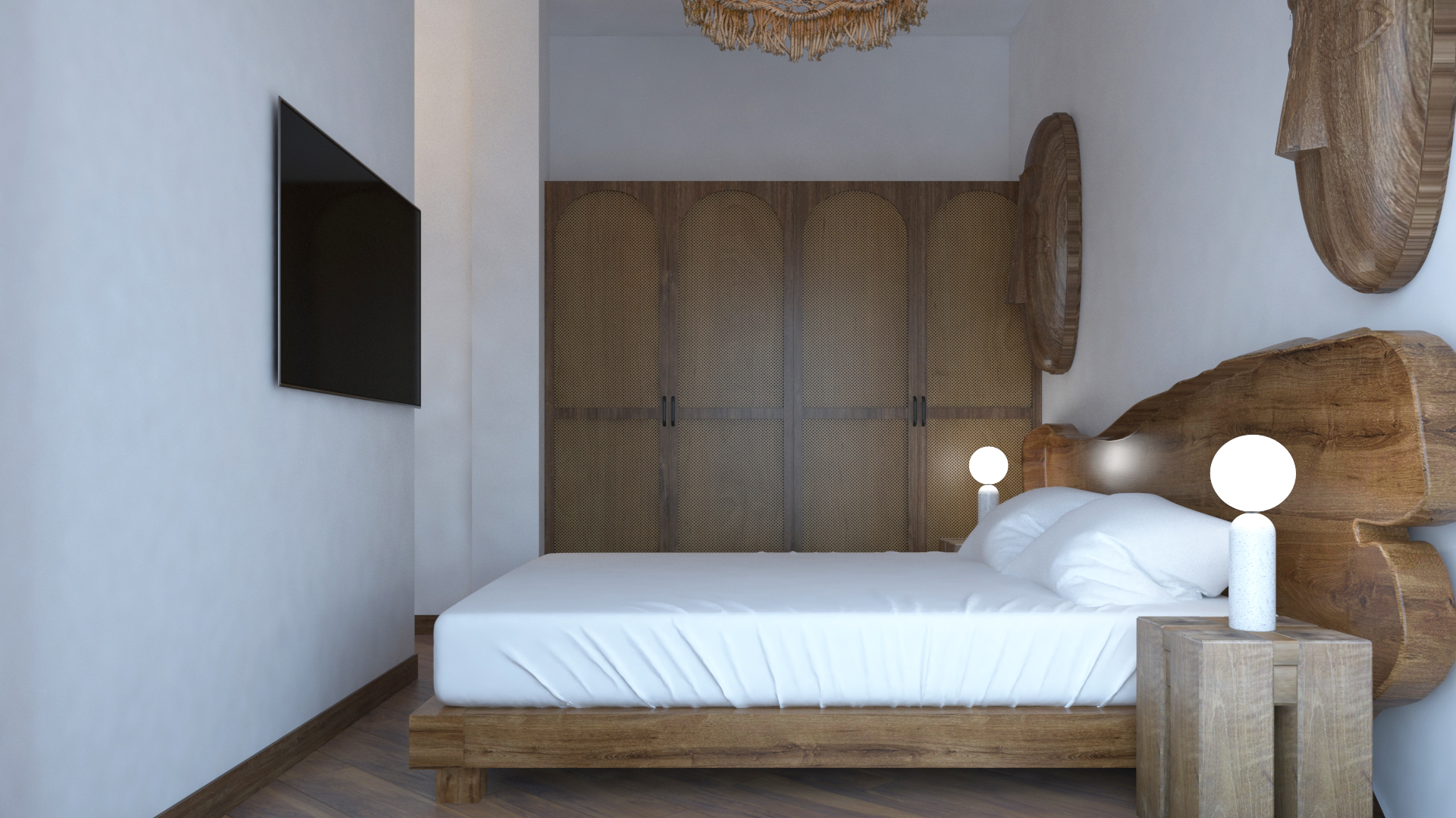 Side view of Bahari Studio bedroom showing rattan wardrobe, live-edge headboard, and wall-mounted TV